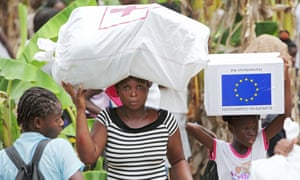 Aid is distributed for victims in Haiti in 2010. The US says it is ending the program because conditions in Haiti have improved, but others called the move ‘heartless’. 