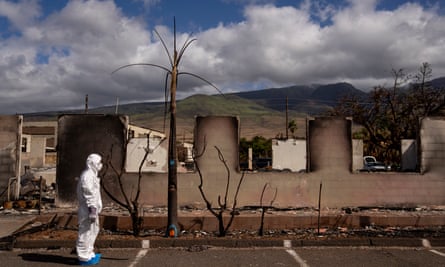 Hironaka stands in front of a ruined building