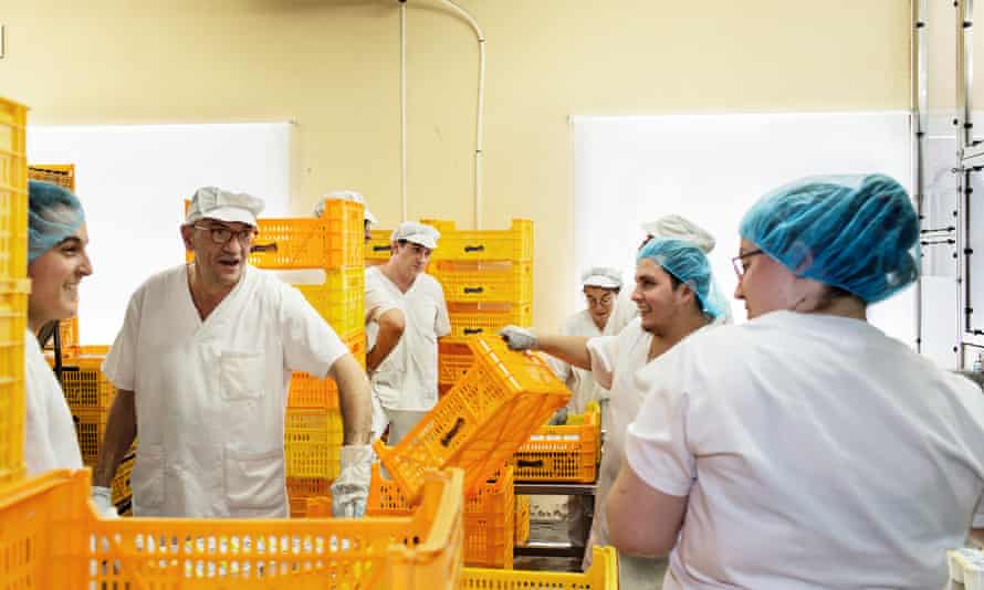 Team work: La Fageda’s workers share a joke in the dairy