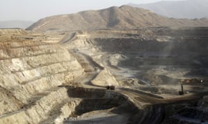 Trucks ferry excavated gold, copper and zinc ore from the main mining pit at the Bisha Mining Share Company in Eritrea.