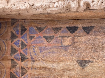 Detail of an old painted wooden door, of interlocking triangles in blue and black