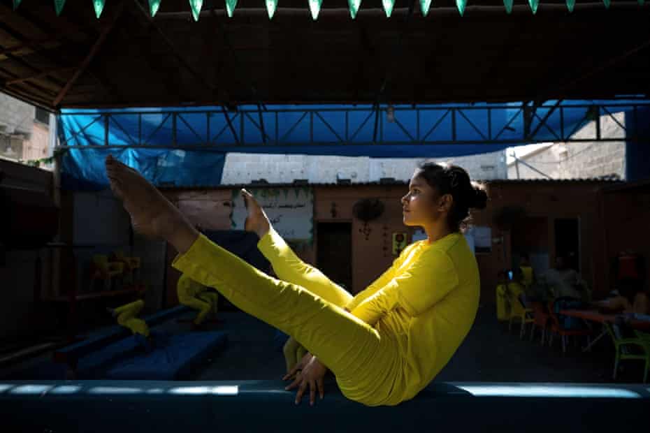 14-year-old gymnast in yellow costume on the beam