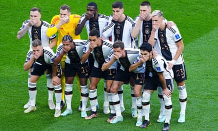 German players cover their mouths in protest before their game against Japan.