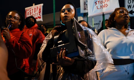 Jasmine Burnett, of Atlanta, center, chants and marches during a protest over plans to build a new police training center in Atlanta on Thursday.