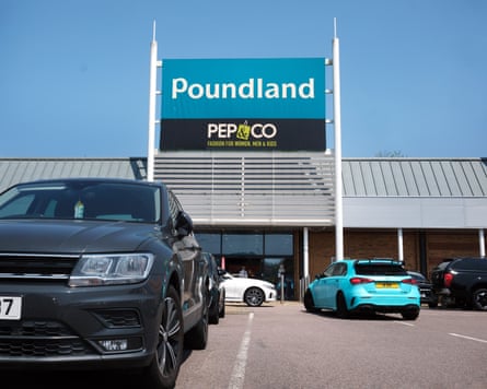 Shoppers’ car park with large Poundland signage in the background
