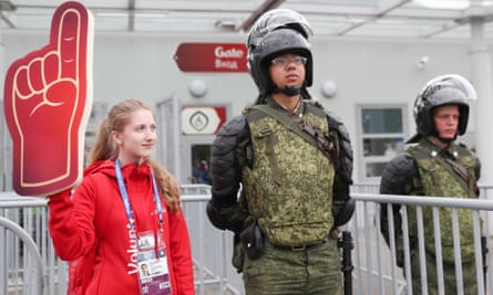 A volunteer stands with a security guard in St Petersburg