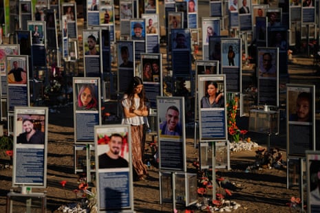 A woman walks through the memorial display at the site of the attack.