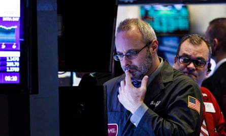 Traders at the New York Stock Exchange keep an eye on the effects of the federal government shutdown.
