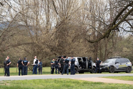 Victoria police next to cars