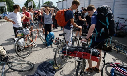 Cyclists from the Critical Mass group make final adjustments to their bikes as they prepare to ride from south-east London to Calais to donate bicycles and supplies to people in the migrant camps.
