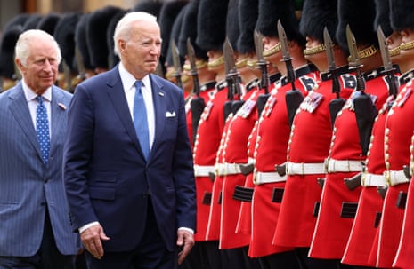 US President Joe Biden and Britain's King Charles III inspect a guard of honour at Windsor Castle