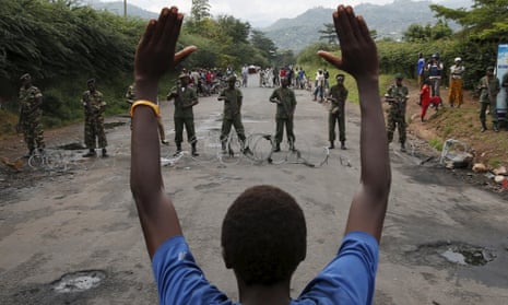 A man stands in front of soldiers outside Burundi’s capital during a protest against president Pierre Nkurunziza.