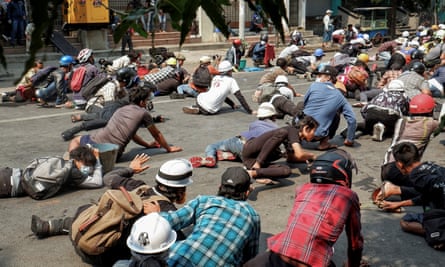 A large group of demonstrators lying on the ground
