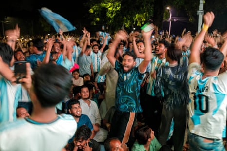 Bangladeshi soccer fans celebrate as Lionel Messi scores a goal.
