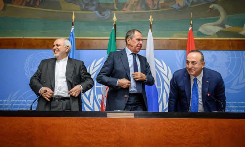 The foreign ministers of Iran, Russia and Turkey at a press conference on a meeting of the Syria committee in Geneva.