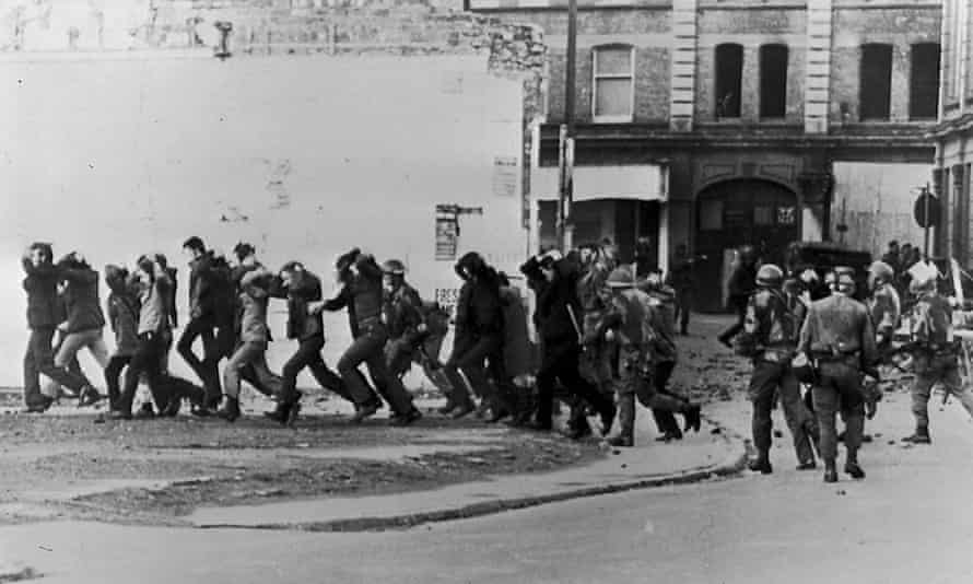 British paratroopers take away civil rights demonstrators after the paratroopers opened fire on a civil rights march in Derry, killing 14 civilians, 30 January 1972