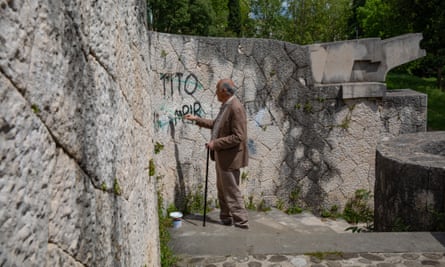 Sead Đulić of the Association of Anti-Fascists paints over derogatory graffiti about Tito, the leader of Yugoslavia from 1945 to 1980 