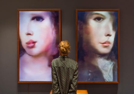 Woman standing in front of two AI generated artworks hung in frames
