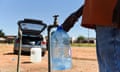 Man fills a container of water from a tap outside the Klipdrift Water Treatment Plant in Hammanskraal in Pretoria