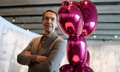 US artist Jeff Koons poses in front of his artwork titled ‘Balloon dog’ 