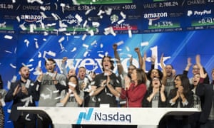 Adam Neumann, in the center, attends the opening ceremony of the Nasdaq bell in New York, January 16, 2018.