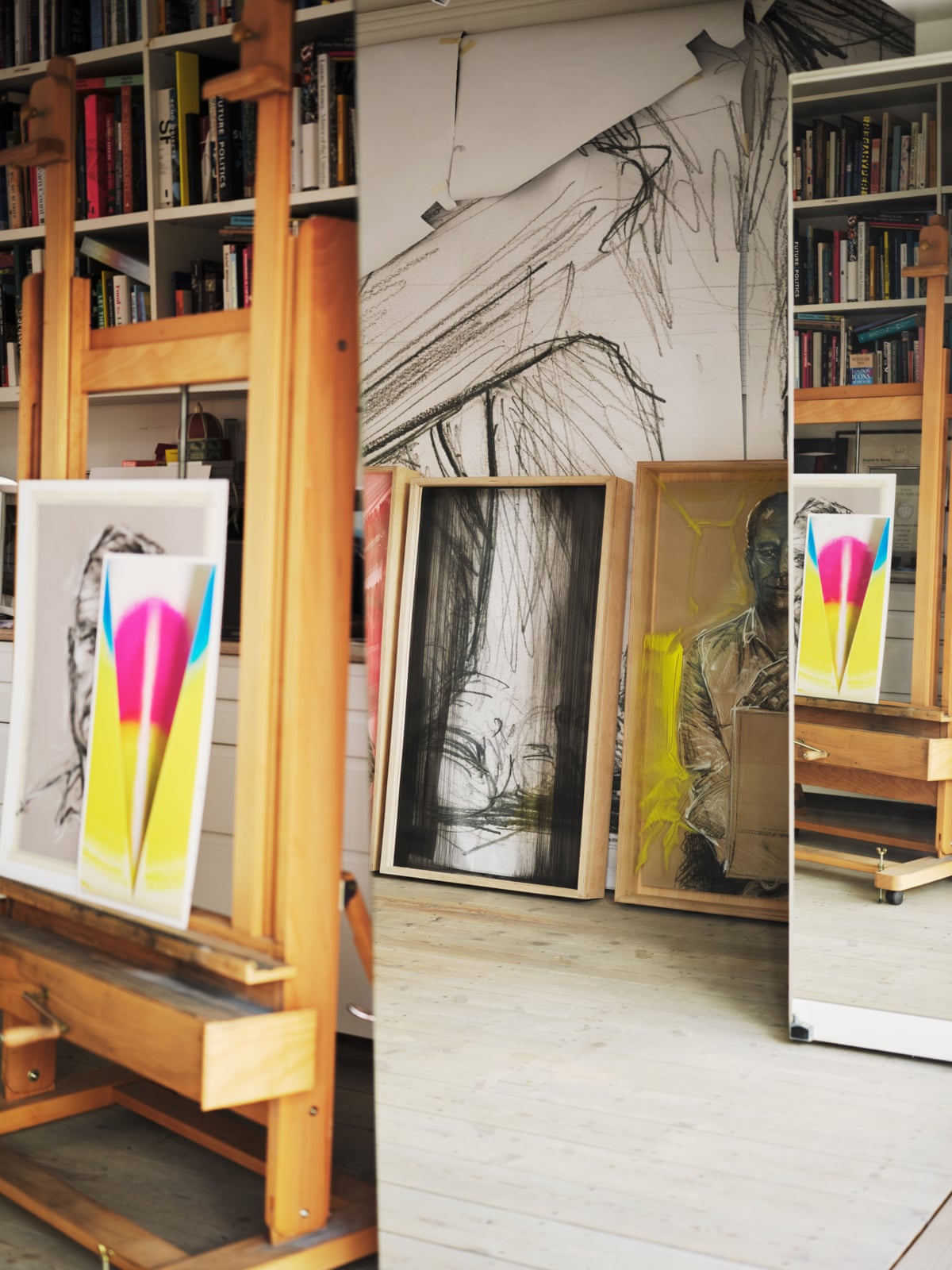 Large artworks propped up against a wall and an easel