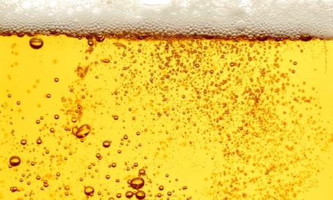 a close up of beer in a glass