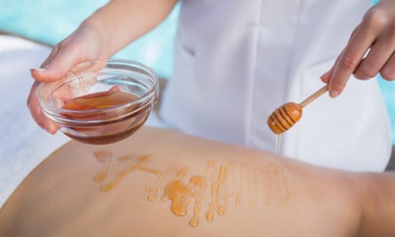 A woman receives a honey beauty treatment.