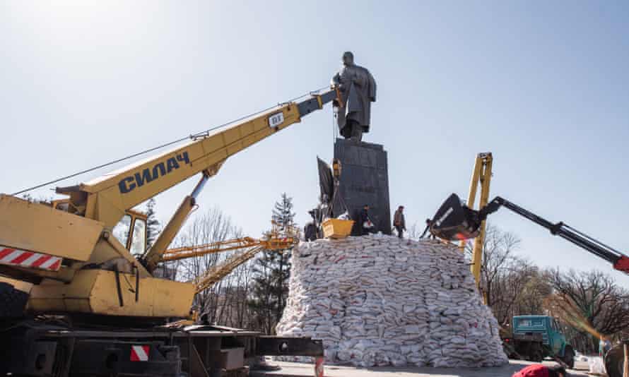 City workers place sandbags around the city statue of Taras Shevchenko to protect it in case of further shelling.