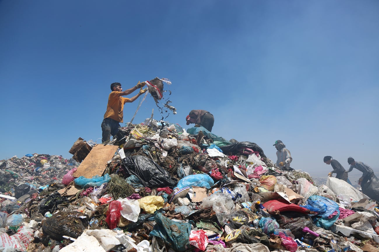 Men search through pieces suitable for recycling at the municipal garbage dump in the south-eastern city of Diyarbakir, Turkey.
