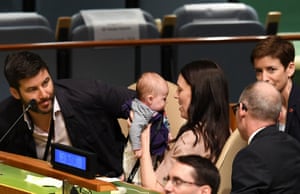Ardern holds daughter Neve beside partner Clarke Gayford, left, at the Nelson Mandela peace summit at UN headquarters in New York in 2018