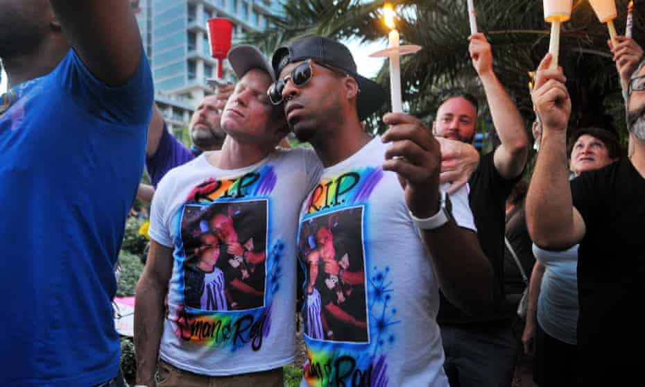 Bryan Manley and Greg Mitchell, who lost their best friend in the Pulse nightclub shooting, join a candlelight vigil at Lake Eola Park in Orlando. 