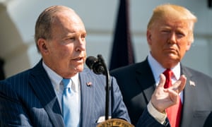 Donald Trump, right, listens to Larry Kudlow, his chief economic adviser, on the lawn of the White House in July