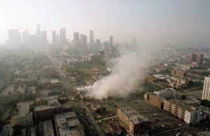 Smoke rises from a shopping center burned by rioters in Los Angeles on 30 April 1992.