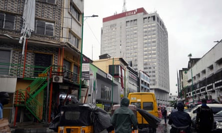 People riding motorbike taxis in front of the African Union Bank headquarters in Lagos, Nigeria