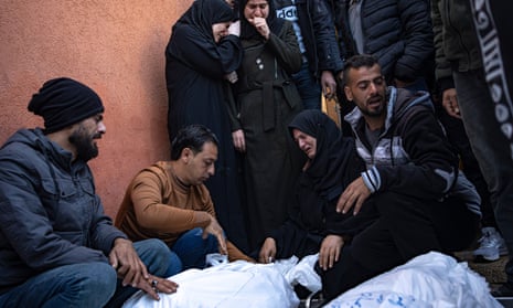 Palestinians mourn their relatives killed in the Israeli bombardment of the Gaza Strip, in the hospital in Khan Younis, Saturday.
