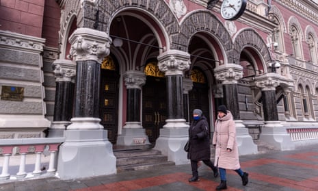 Women in Kyiv wear face masks on the street.