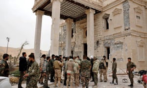 Forces loyal to Syria’s President Bashar al-Assad gather at a palace complex on the western edge of Palmyra.