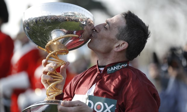 Davy Russellk kisses the trophy as he celebrates after riding Tiger Roll to victory.