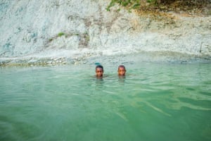 Two boys taking a bath in a pool in the Central Plateau
