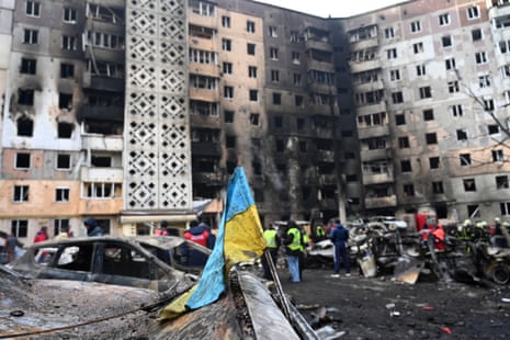 A Ukrainian flag is seen attached to a burned car at the site of a heavily damaged residential building following a Russian airstrike in the city of Ternopil, on 19 November, 2025.