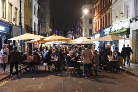 People dine out in London’s Soho neighbourhood before 10pm.