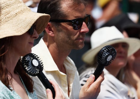 Spectators in the stands of court 16 use fans to cool down amid the heatwave during the first round match between Slovenia’s Veronika Erjavec and Ukraine’s Marta Kostyuk at the Wimbledon tennis tournament.