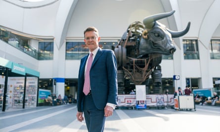 Andy Street in New Street Station next to Ozzy the giant bull