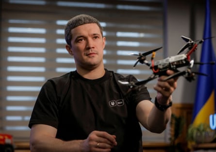 Mykhailo Fedorov wearing a black T-shirt and holding a drone