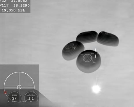 The spacecraft deploys parachutes before splashdown