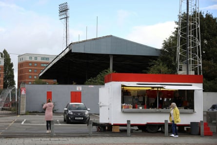Women wait at a mobile sandwich bar outside The Racecourse Stadium on Thursday.