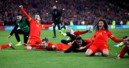 Aaron Ramsey (left), Gareth Bale and Ethan Ampadu celebrate qualification for Euro 2020 with their teammates in November 2019.