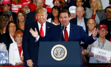 Donald Trump stands behind Ron DeSantis during a rally in 2018 when they were on better terms