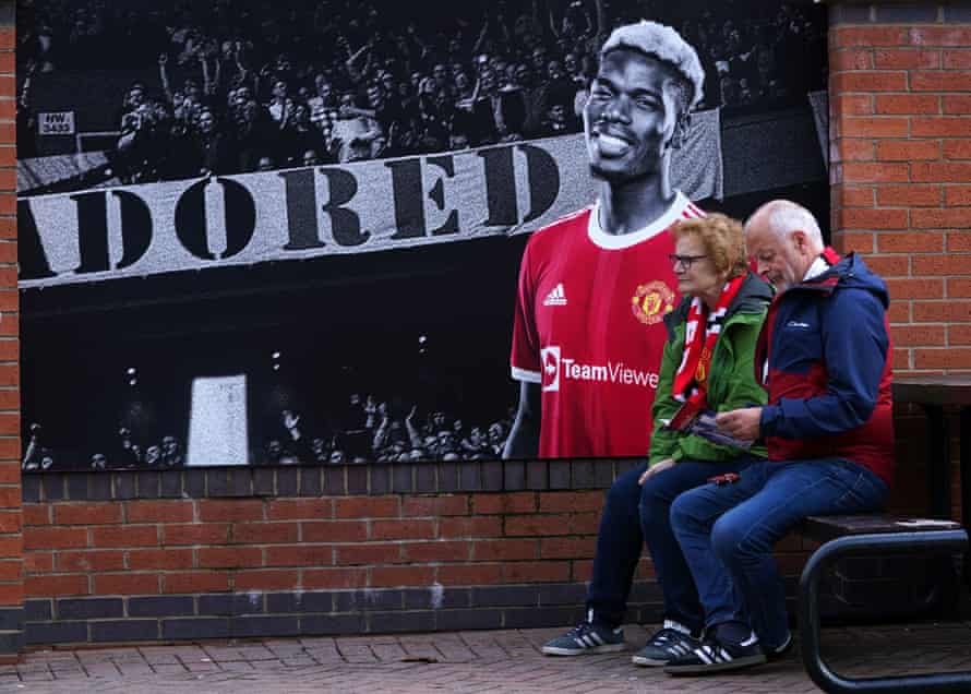 Manchester United fans next to a mural of Paul Pogba last October before the 5-0 home defeat by Liverpool in which he was sent off.